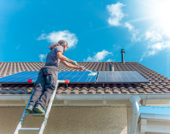 Affordable Roofing & Solar team cleaning solar panels